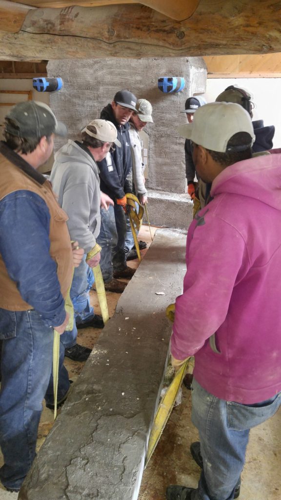 Contractors lifting heavy piece of wood - Jackson Hole Bed and Breakfast